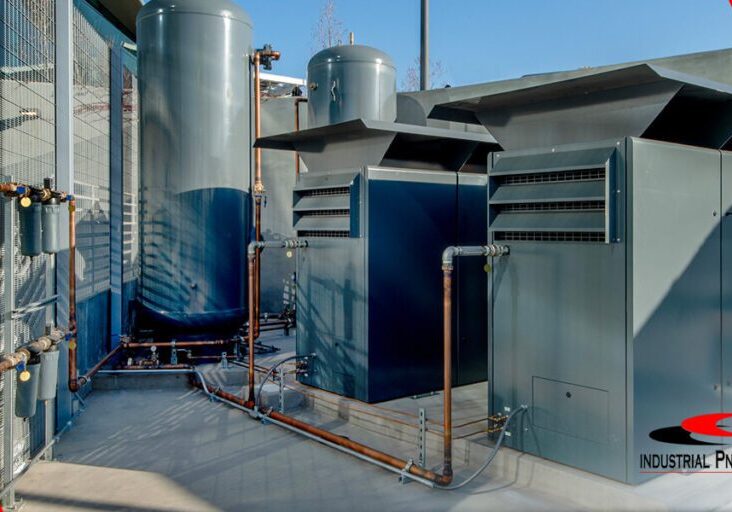 several industrial air compressors outdoors